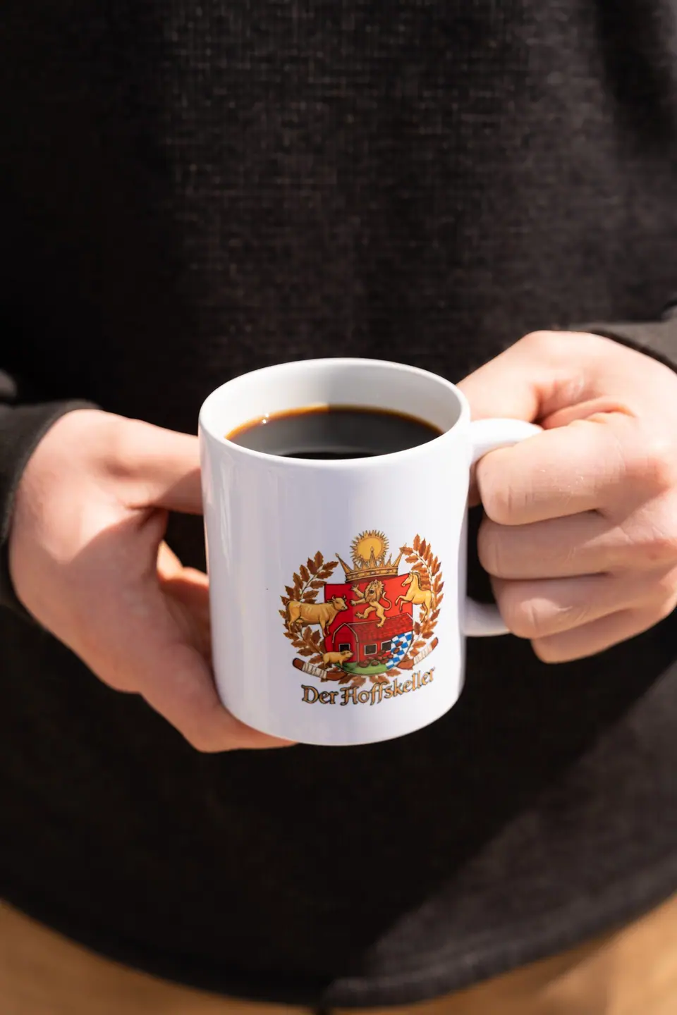 max holding a cup of gooooood coffee